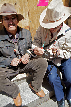 These men inspected and talked about each stone on their necklaces.