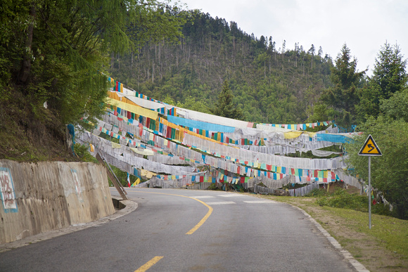 More prayer flags across the roadway.