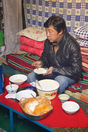 Bianba preparing his own breakfast - tsampa again.