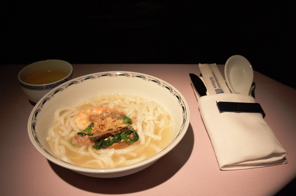 Mid-flight snack is Taiwanese-style noodles with Chinese tea.  I also had the cake.