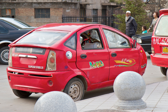 A 3-wheeled Prius outside the monastery.