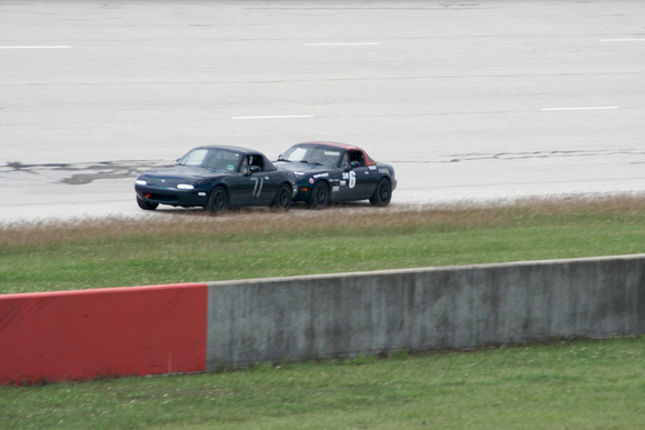 A sequence of two miatas practicing the draft